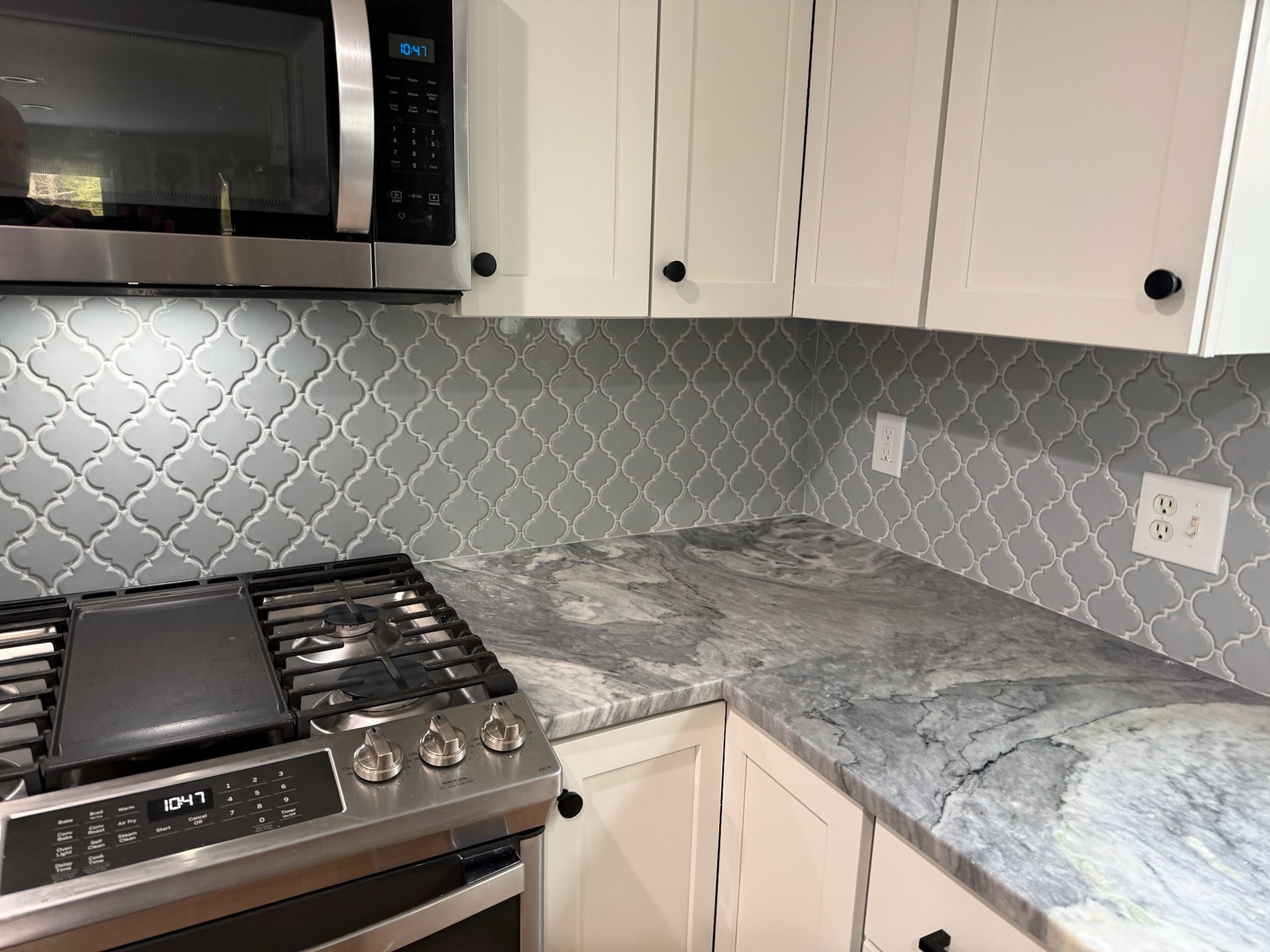 Gray arabesque tile with marble countertop