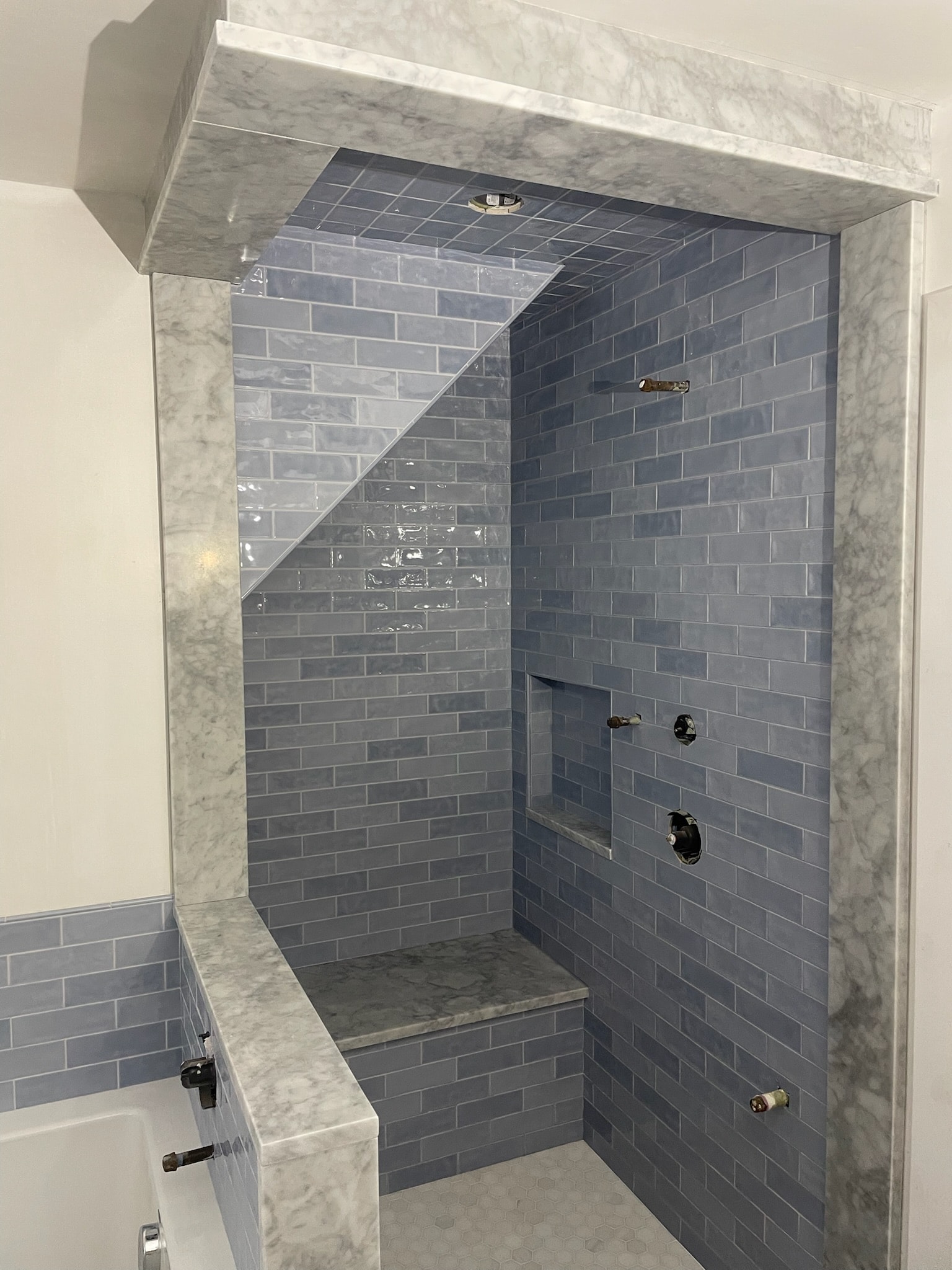 Stone tile shower with herringbone ceiling